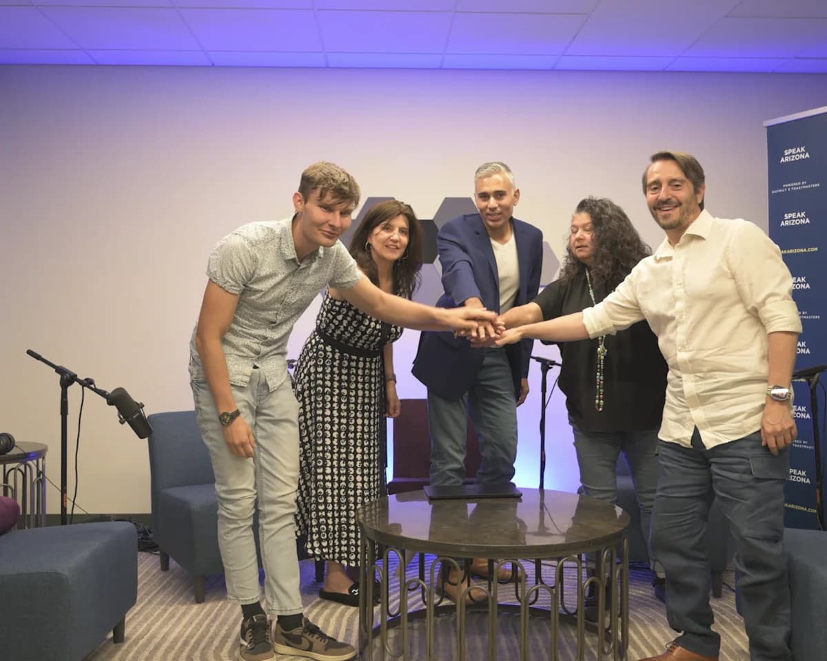 The Speak Arizona team, Matthew Malan, Marie Feutrier, Rupesh Parbhoo, Edna Saucke, and Vincent Feutrier, joining hands in the studio for Episode 100